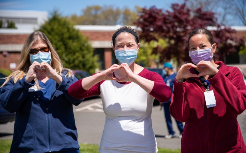 nurses wearing masks and doing heart hands