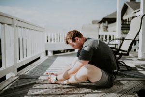 picture of a man doing leg workouts and stretching outside