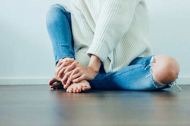 woman hiding her foot