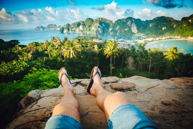 legs on a rock looking at scenery