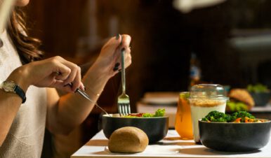 woman eating a salad to get her daily dose of healthy vitamins