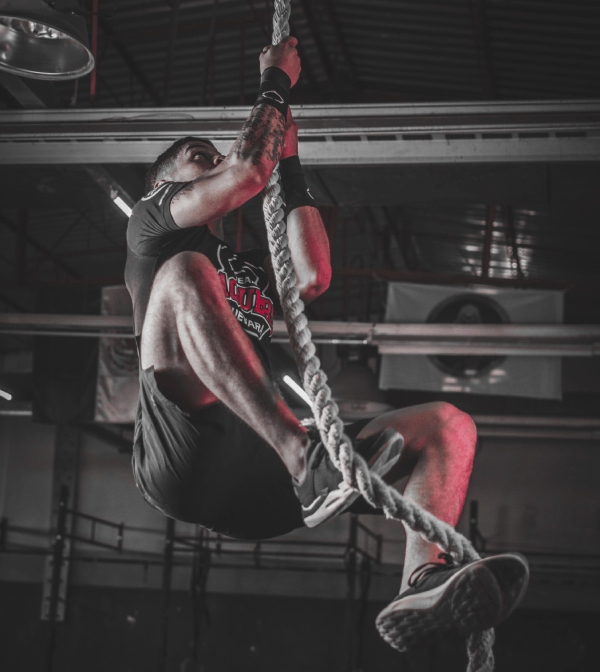 man climbing rope