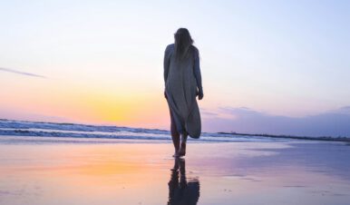 perimenopause and menopause linked to varicose veins -woman on the beach for vss blog header
