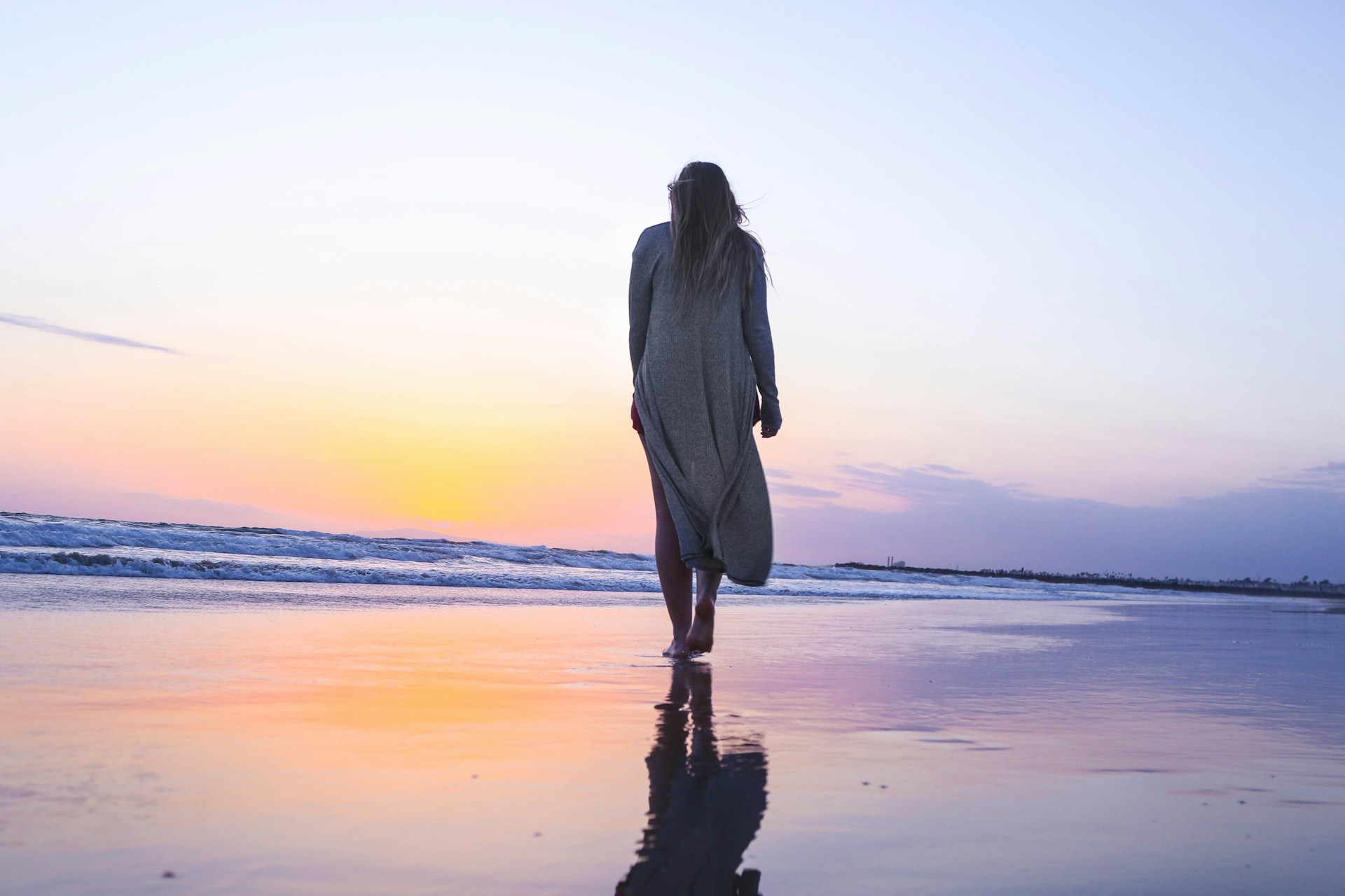 perimenopause and menopause linked to varicose veins -woman on the beach for vss blog header